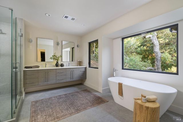 a bathroom with a tub and mirror