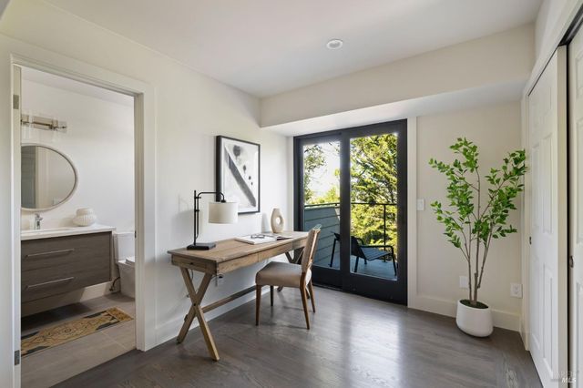 a workspace with furniture window and wooden floor