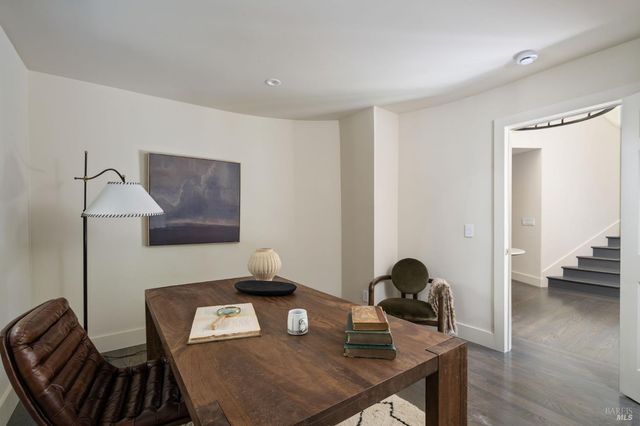 a view of a workspace with furniture and wooden floor