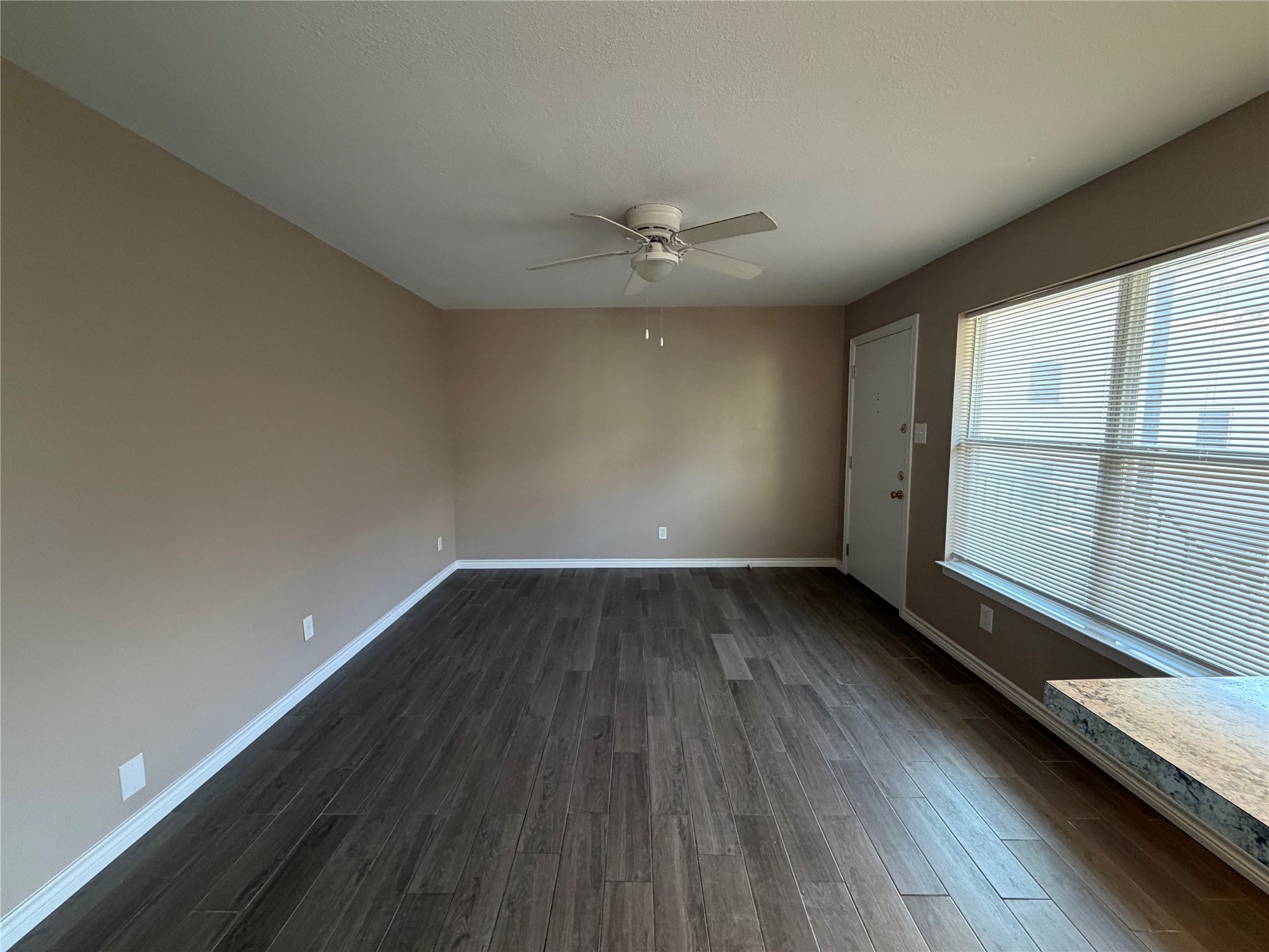 3113 Arbor Street, Unit 3 Houston, TX 77004 - Photo 3 of 11 an empty room with wooden floor and windows