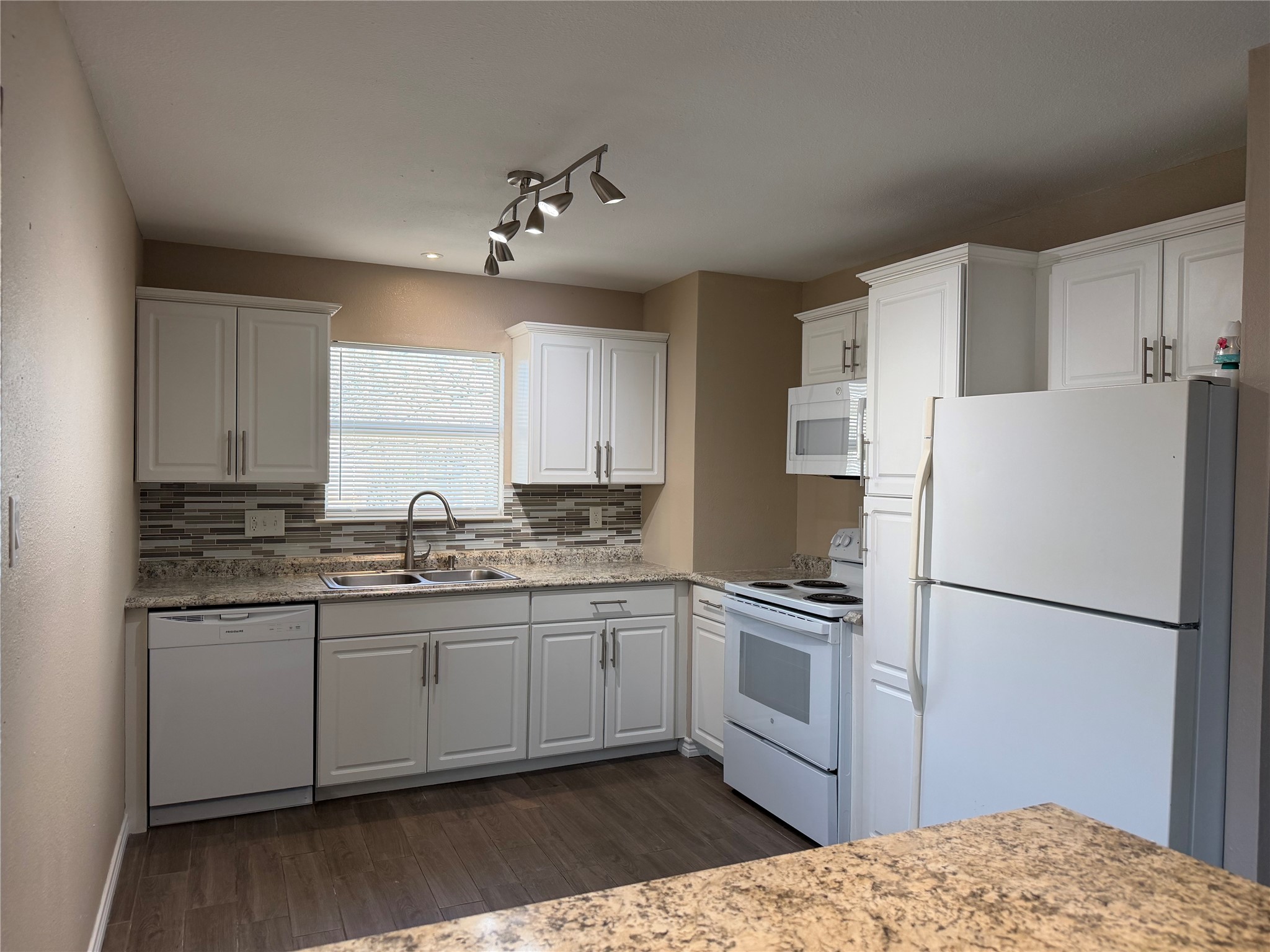 3113 Arbor Street, Unit 3 Houston, TX 77004 - Photo 4 of 11 a kitchen with stainless steel appliances granite countertop a refrigerator sink and cabinets