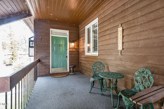 a view of a porch with chairs and a table