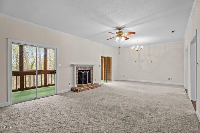 a view of an empty room with a fireplace