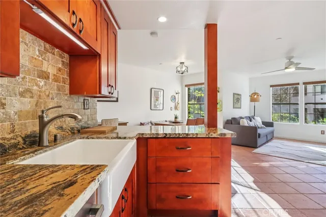 a kitchen with stainless steel appliances kitchen island granite countertop a refrigerator oven stove a sink and dishwasher