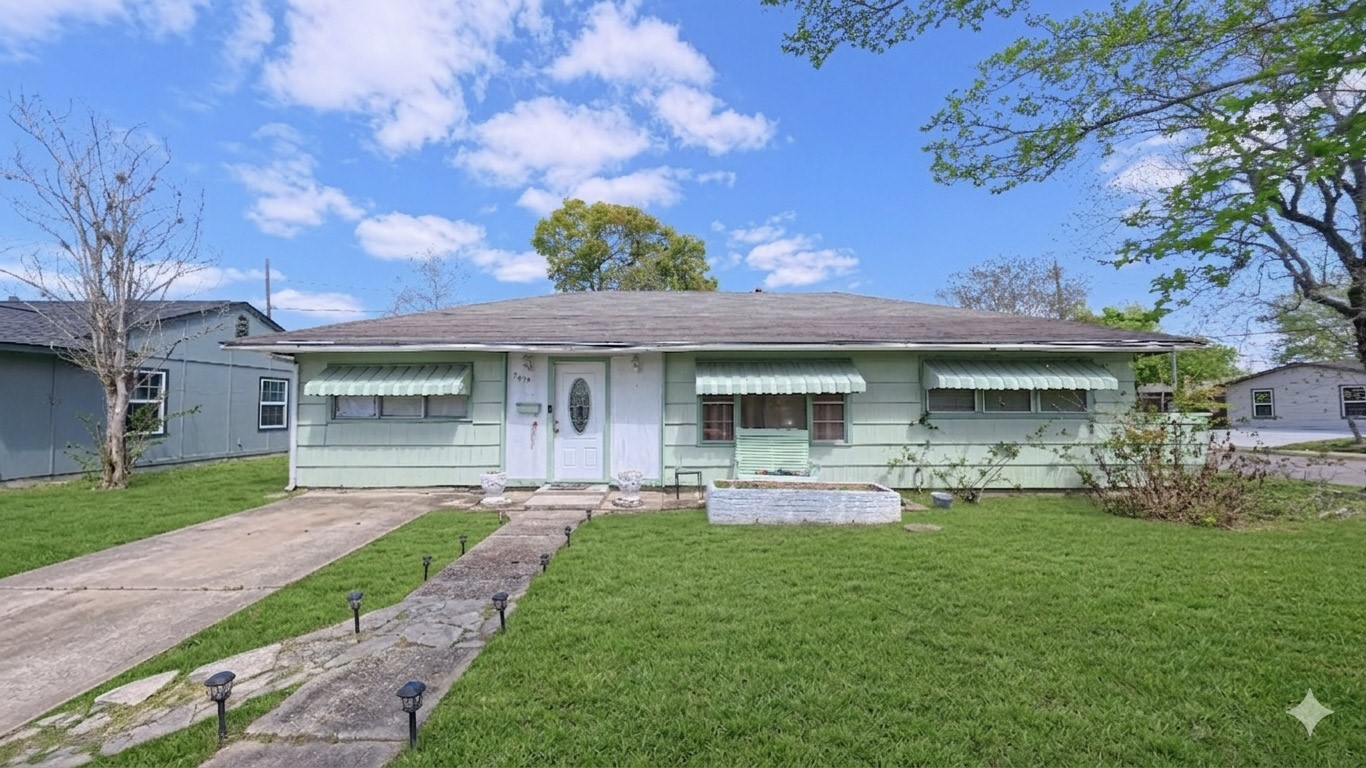 5879 Belneath Street Houston, TX 77033 - Photo 1 of 10 a front view of a house with a garden and porch