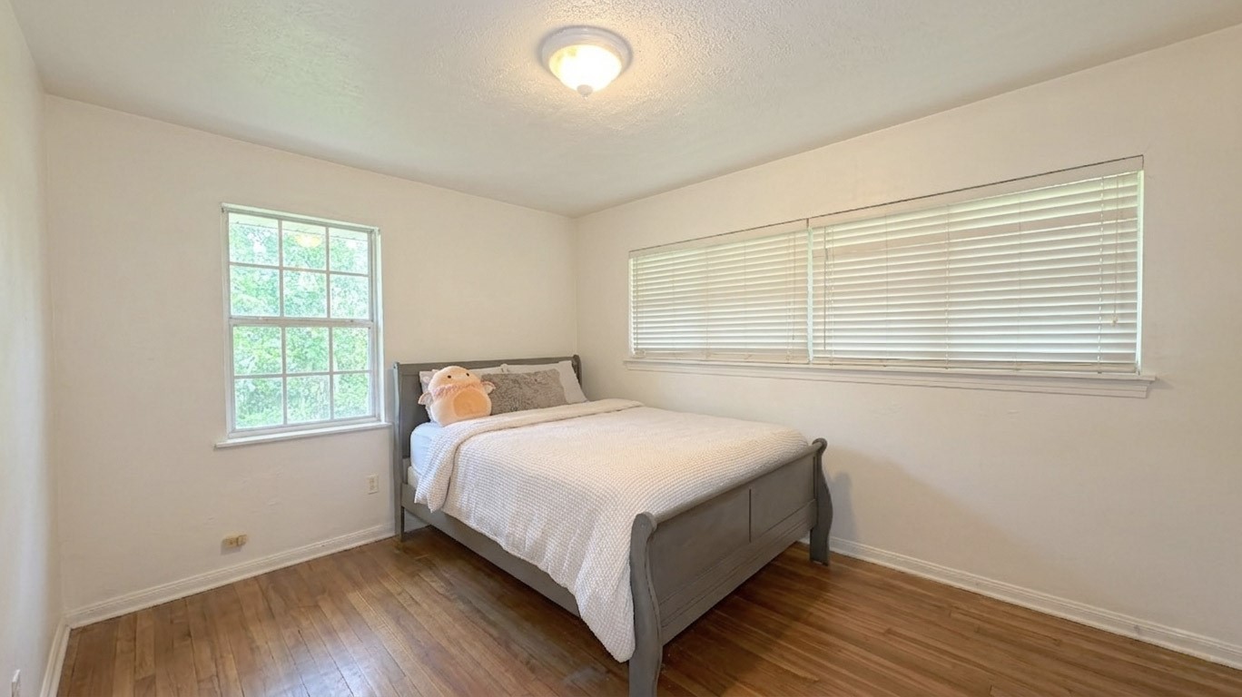 5879 Belneath Street Houston, TX 77033 - Photo 3 of 10 a bedroom with a bed and window