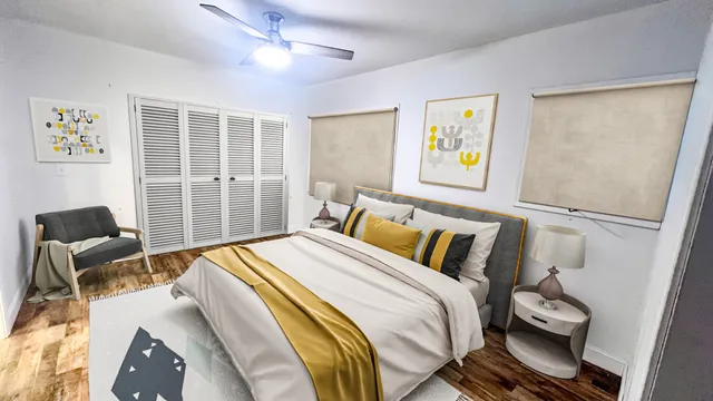 a bedroom with a bed and wooden floor