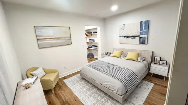 a bedroom with a bed and the couch