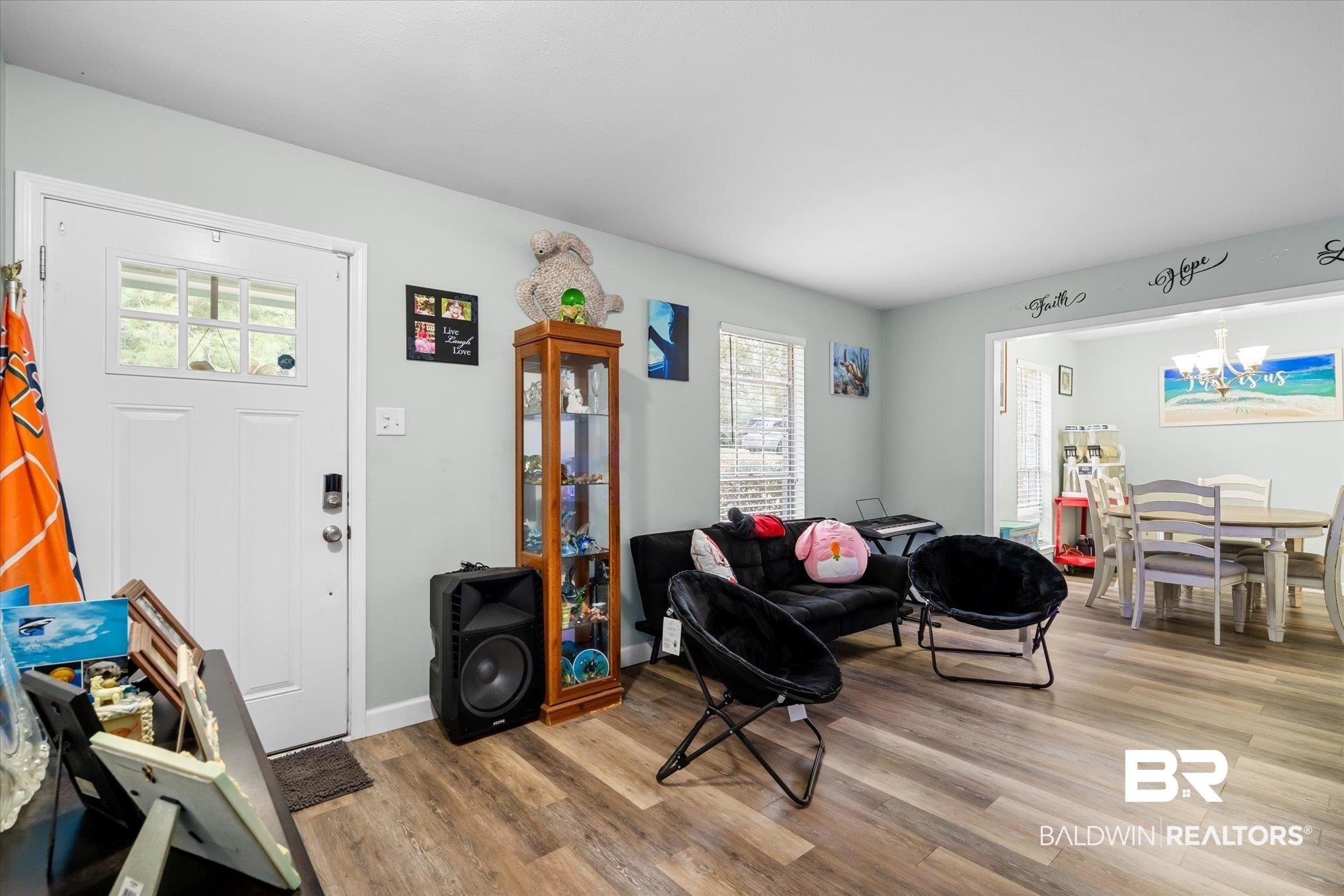 9987 Downing Street Semmes, AL 36575 - Photo 2 of 20 Living room with light wood-type flooring and a notable chandelier