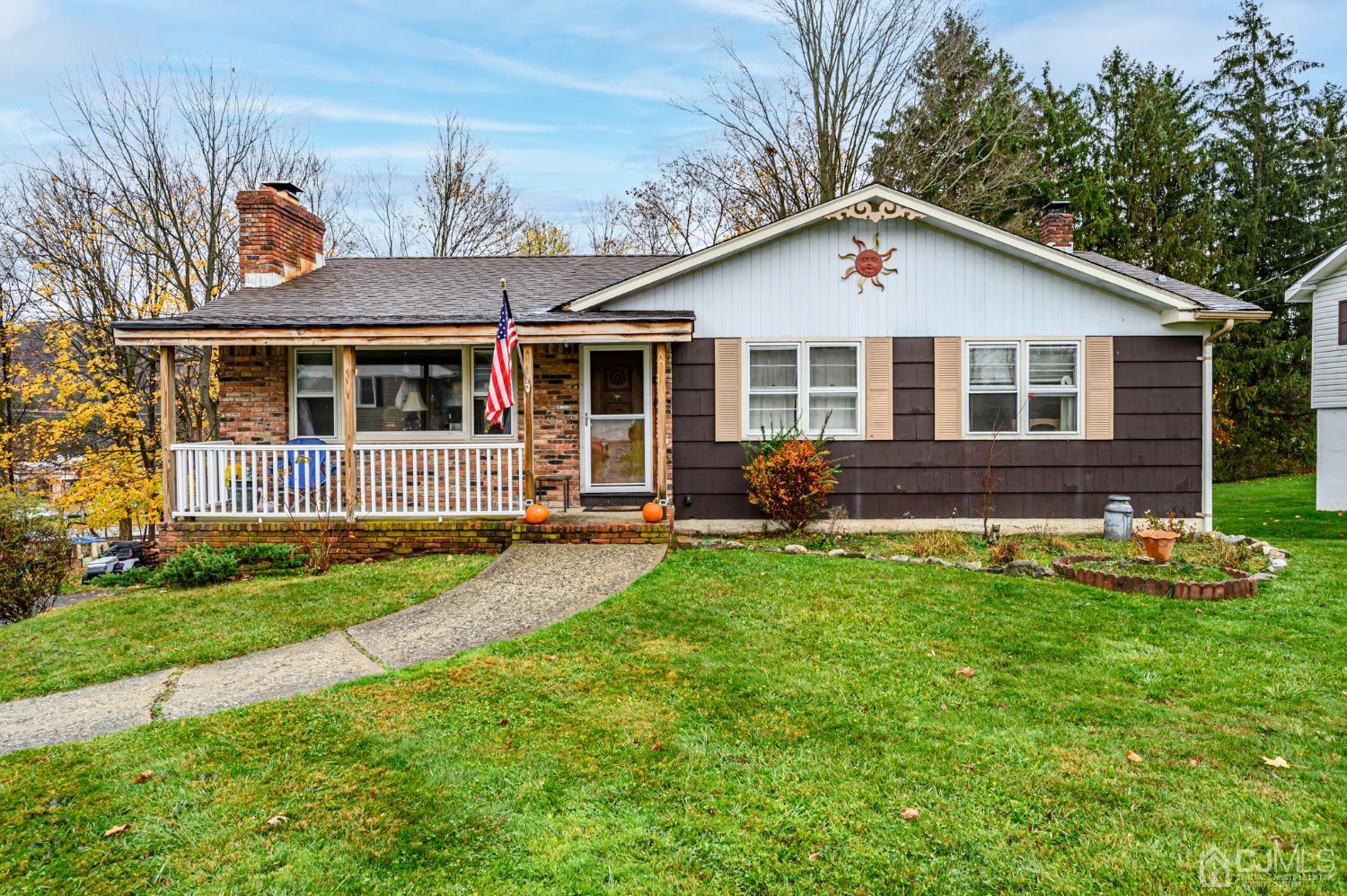 a view of a house with a yard patio and a garden