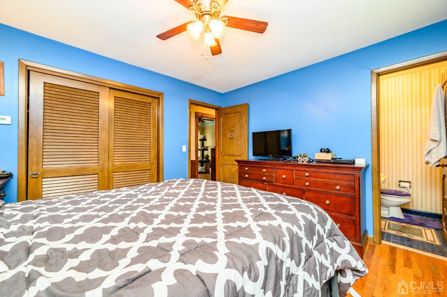 7 Lozaw Road Franklin, NJ 07416 - Photo 22 of 27 a bedroom with a bed and a chandelier
