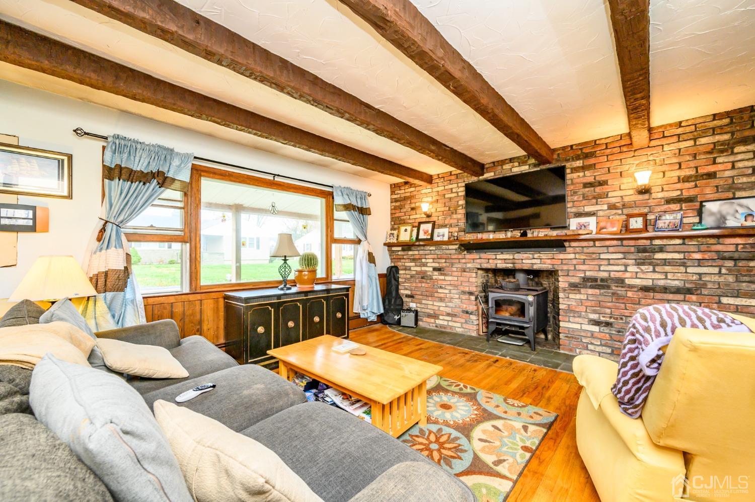 7 Lozaw Road Franklin, NJ 07416 - Photo 6 of 27 a living room with furniture a fireplace and a flat screen tv