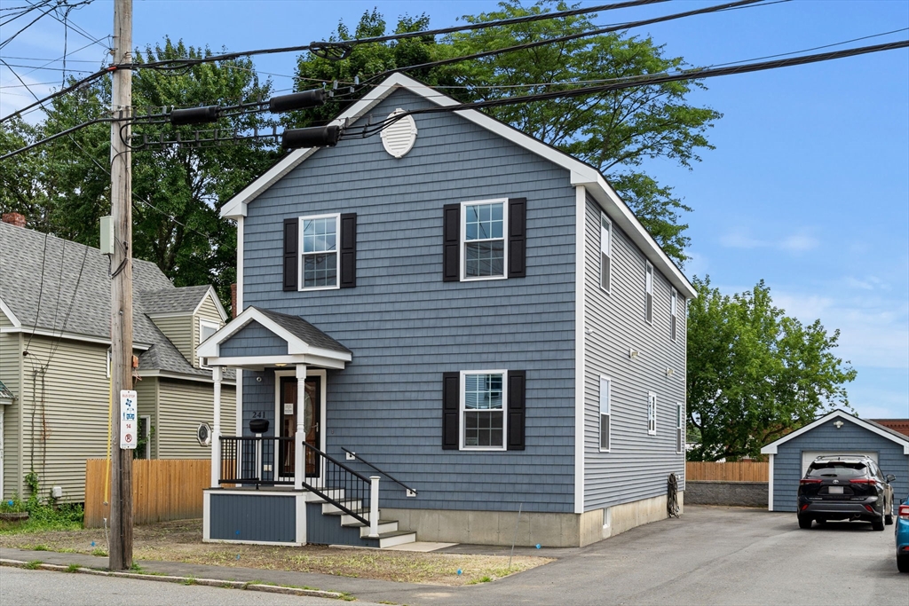 241 Plain Street Lowell, MA 01852 - Photo 1 of 33 a front view of a house with garage