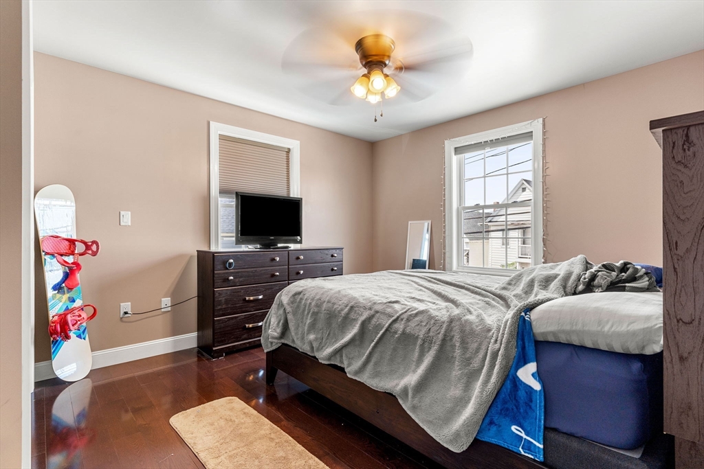 241 Plain Street Lowell, MA 01852 - Photo 15 of 33 a bedroom with a bed and a flat screen tv