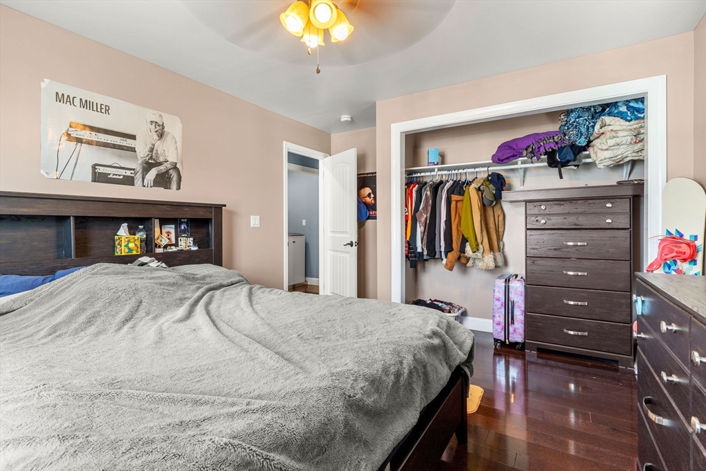 241 Plain Street Lowell, MA 01852 - Photo 16 of 33 a bedroom with a bed and a cabinet