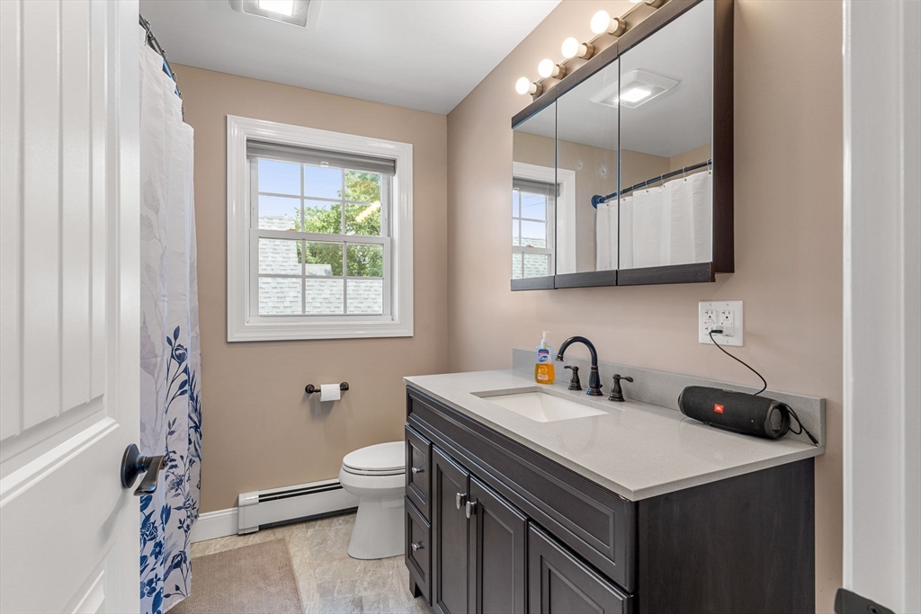 241 Plain Street Lowell, MA 01852 - Photo 19 of 33 a bathroom with a sink and a toilet