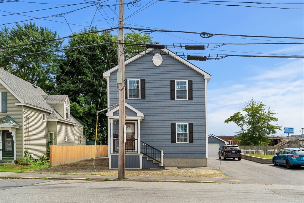 241 Plain Street Lowell, MA 01852 - Photo 2 of 33 a view of a house with a yard