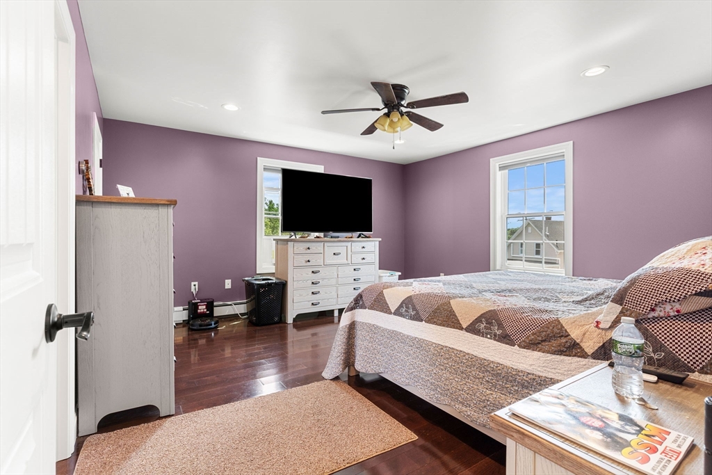 241 Plain Street Lowell, MA 01852 - Photo 21 of 33 a bed room with a bed a television and a couch