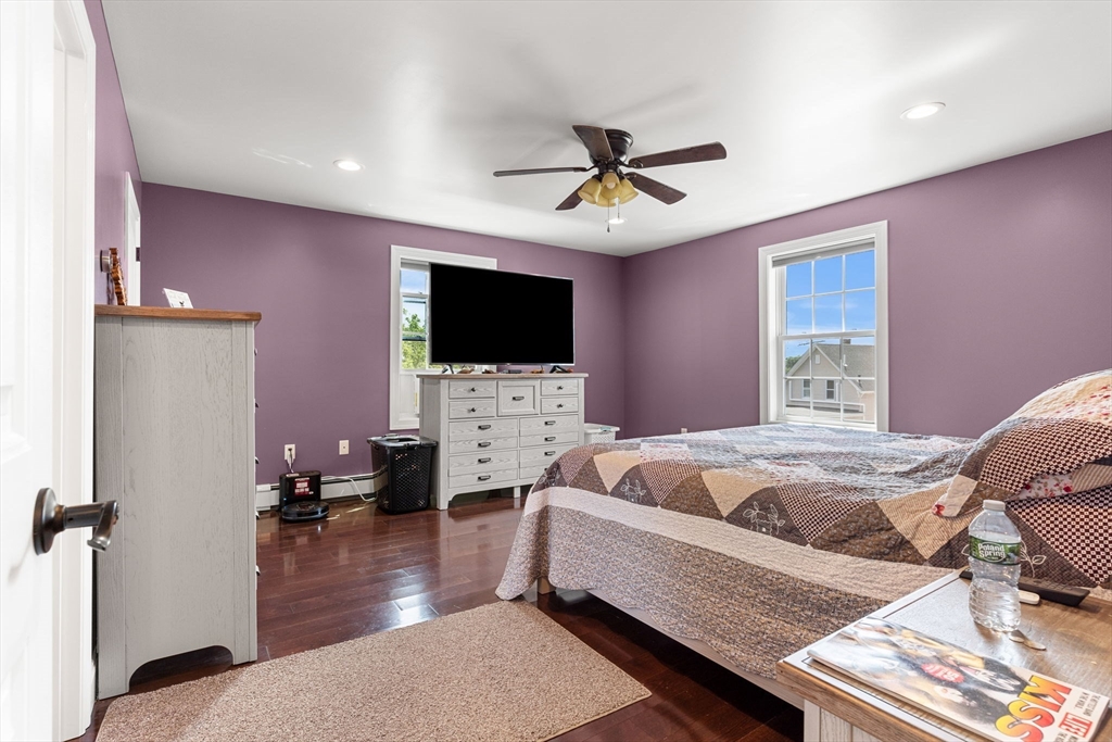 241 Plain Street Lowell, MA 01852 - Photo 22 of 33 a bedroom with furniture and a flat screen tv