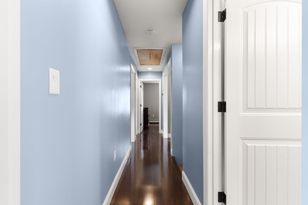 241 Plain Street Lowell, MA 01852 - Photo 24 of 33 a view of a hallway with wooden floor