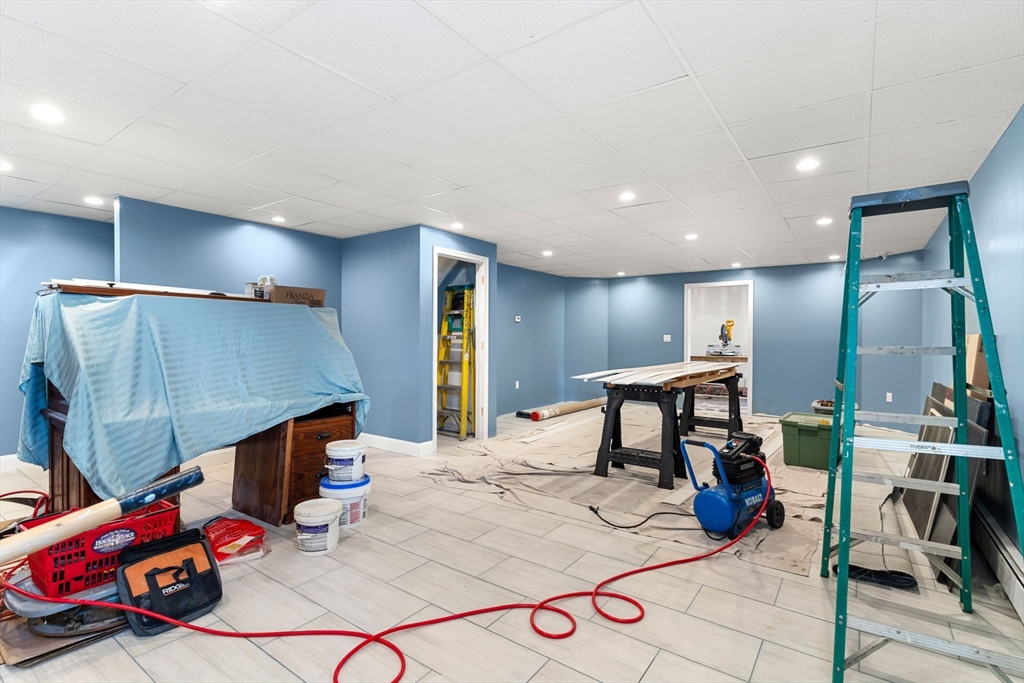 241 Plain Street Lowell, MA 01852 - Photo 27 of 33 a living room with furniture a wooden floor and a sink