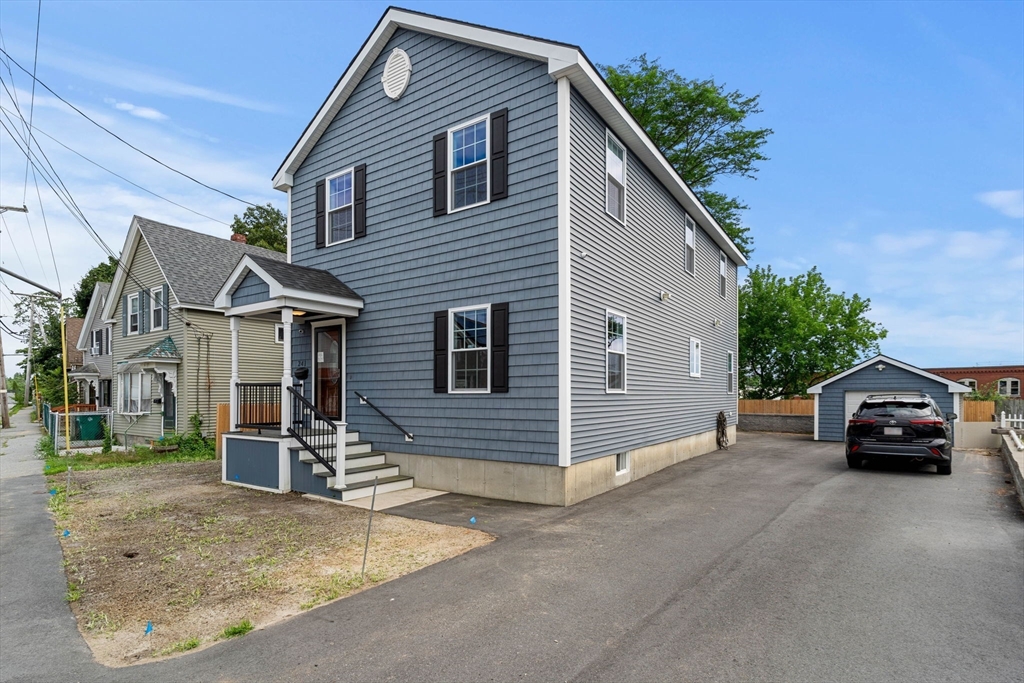 241 Plain Street Lowell, MA 01852 - Photo 3 of 33 a view of a car parked in front of a house