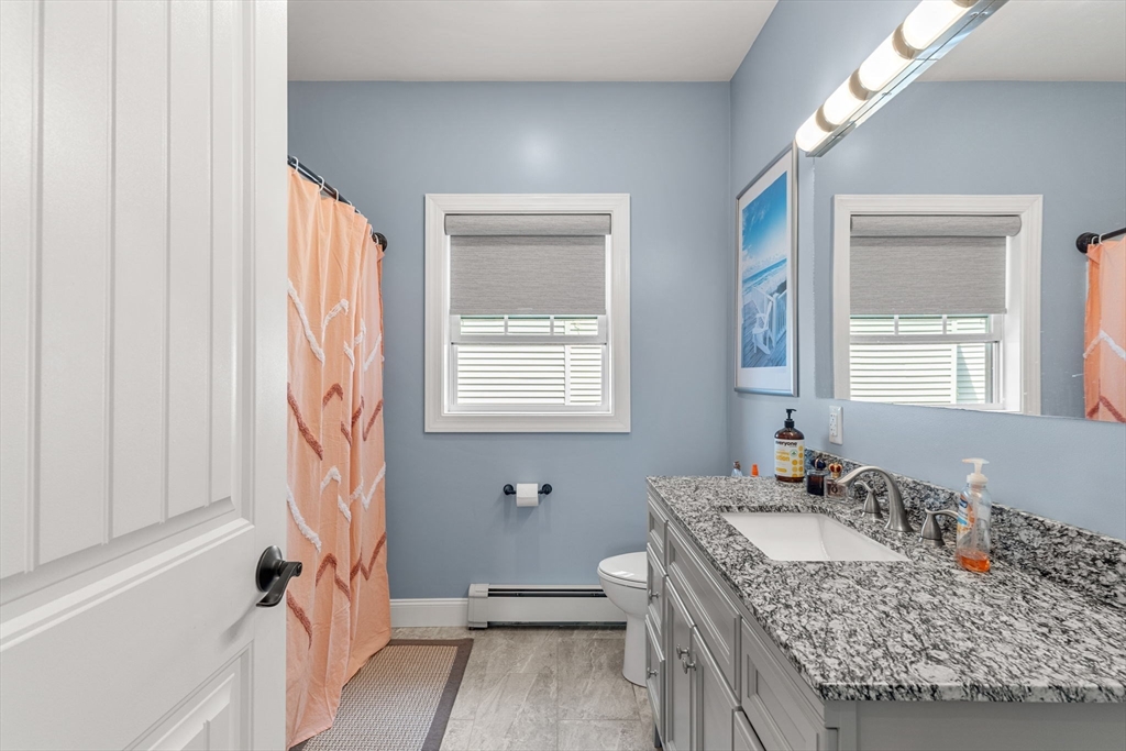 241 Plain Street Lowell, MA 01852 - Photo 5 of 33 a bathroom with a granite countertop sink and a mirror