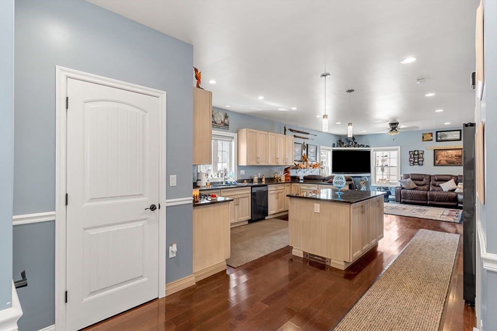 241 Plain Street Lowell, MA 01852 - Photo 7 of 33 a kitchen with a refrigerator and a stove top oven