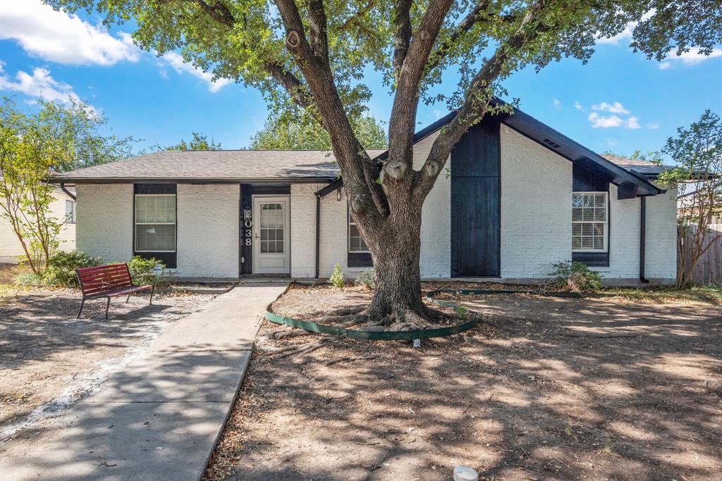 a backyard of a house with table and chairs