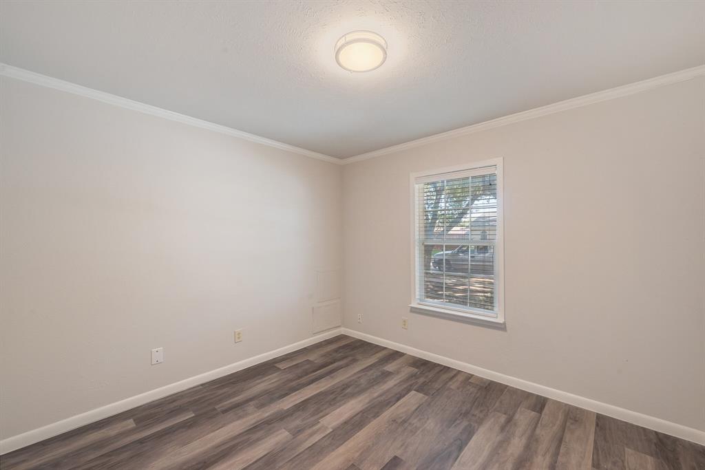 2038 Ash Hill Road Carrollton, TX 75007 - Photo 14 of 28 an empty room with wooden floor and windows