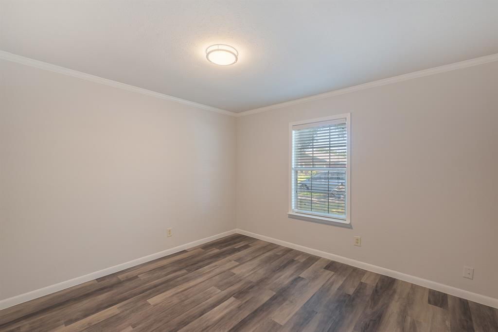 2038 Ash Hill Road Carrollton, TX 75007 - Photo 16 of 28 wooden floor in an empty room with a window