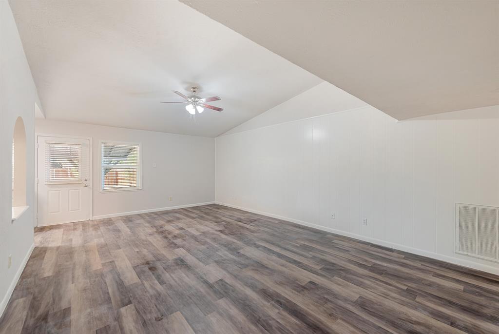 2038 Ash Hill Road Carrollton, TX 75007 - Photo 19 of 28 a view of an empty room with wooden floor