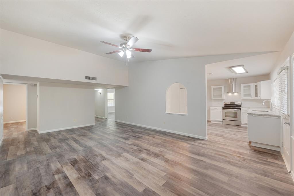 2038 Ash Hill Road Carrollton, TX 75007 - Photo 21 of 28 a view of a kitchen with wooden cabinet and a ceiling fan