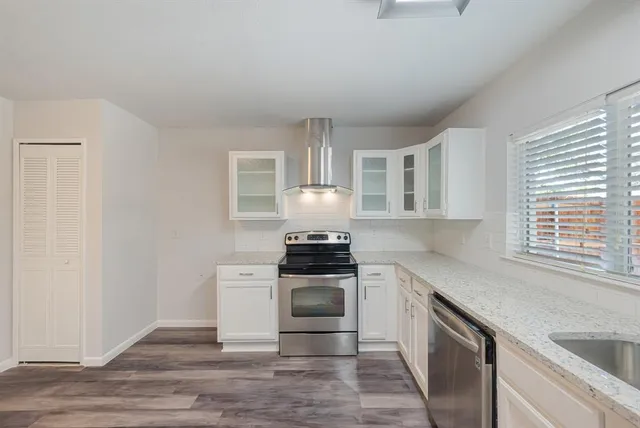 a kitchen with a stove oven and sink
