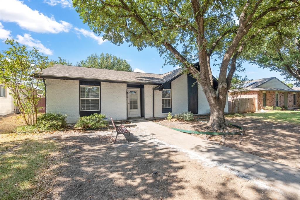 2038 Ash Hill Road Carrollton, TX 75007 - Photo 3 of 28 a front view of a house with a garden
