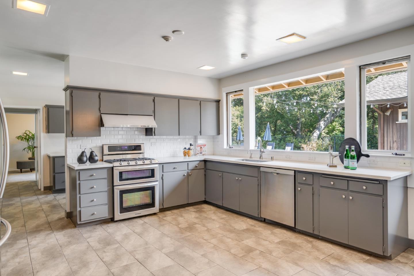 760 Chiltern Road Hillsborough, CA 94010 - Photo 18 of 56 a kitchen with stainless steel appliances granite countertop a stove sink and cabinets