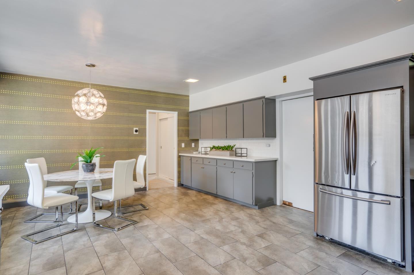 760 Chiltern Road Hillsborough, CA 94010 - Photo 19 of 56 a kitchen with stainless steel appliances a refrigerator and a stove top oven