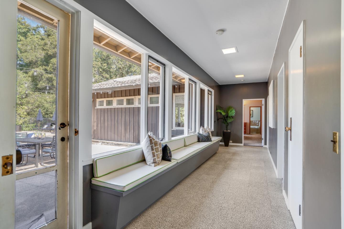 760 Chiltern Road Hillsborough, CA 94010 - Photo 24 of 56 a living room with furniture and large windows