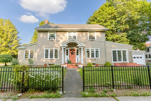 a front view of a house with a garden