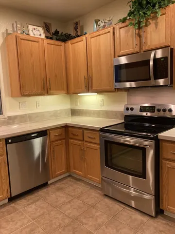 a kitchen with granite countertop a stove microwave and sink