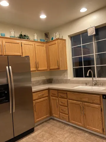 a kitchen with cabinets and stainless steel appliances