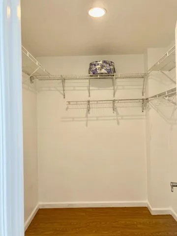 a living room with hard wood floor and a table