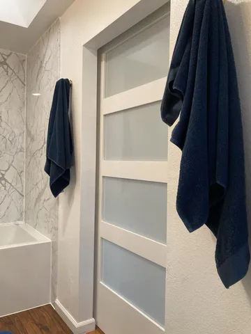 a backyard of a house with barbeque oven wooden floor and outdoor seating