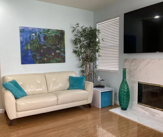 a living room with furniture and a fireplace