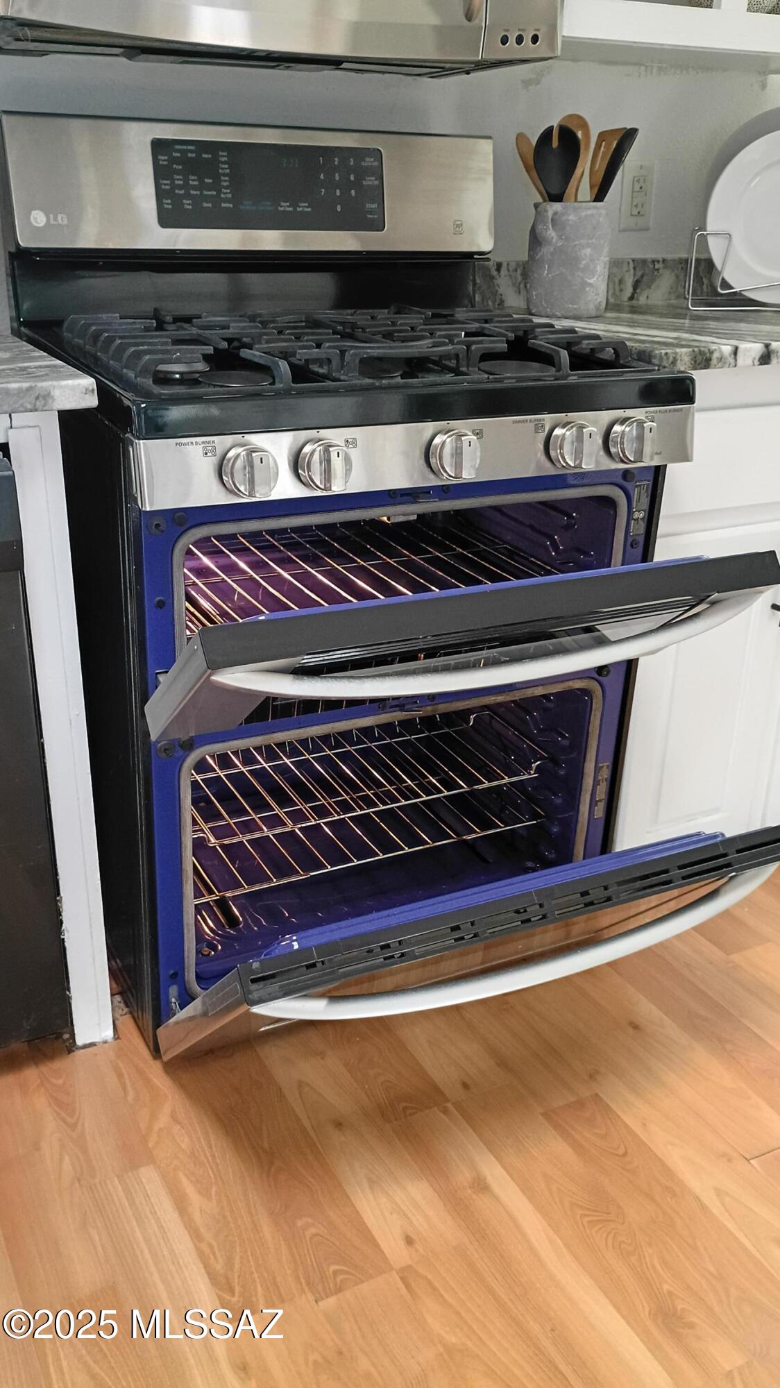 1449 West Hualpai Road Tucson, AZ 85745 - Photo 18 of 49 a stove top oven sitting inside of a kitchen