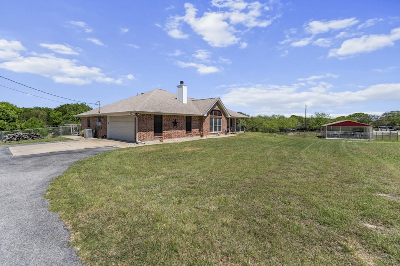 249 County Road 4961 Kempner, TX 76539 - Photo 30 of 31 a front view of a house with a garden and lake view