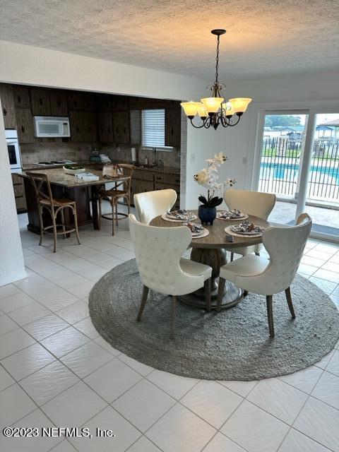 4345 Cedar Road Orange Park, FL 32065 - Photo 13 of 57 a dining room with furniture a chandelier and window