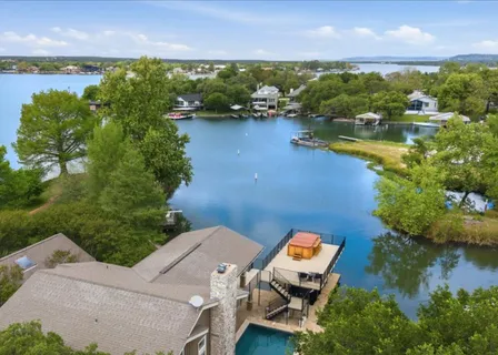 an aerial view of a house with a lake view