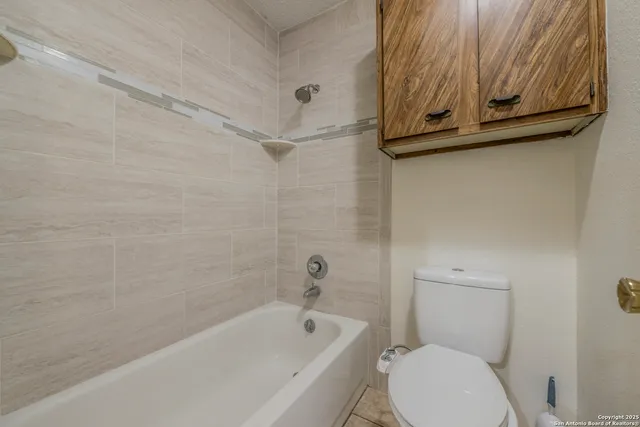 a bathroom with a toilet and bathtub