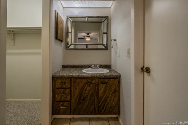 a bathroom with a sink and a mirror